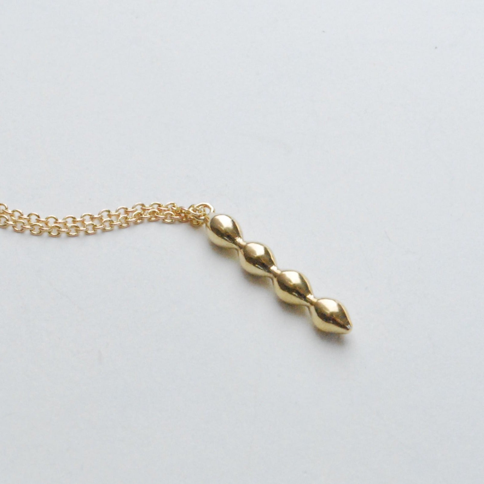 Close up of the bubble charm in bronze on a white background