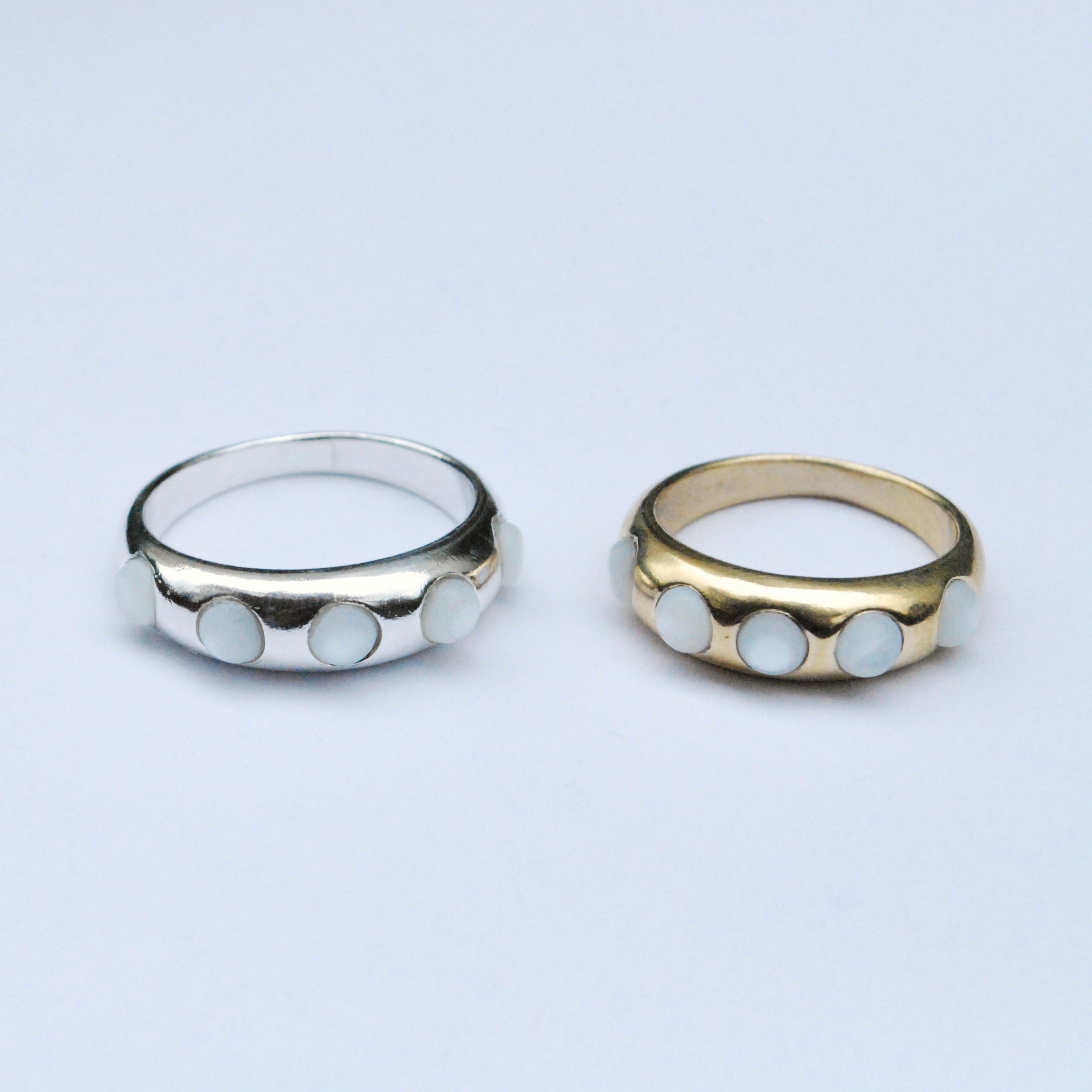 Silver and gold bands with white mother of pearl cabochon stones