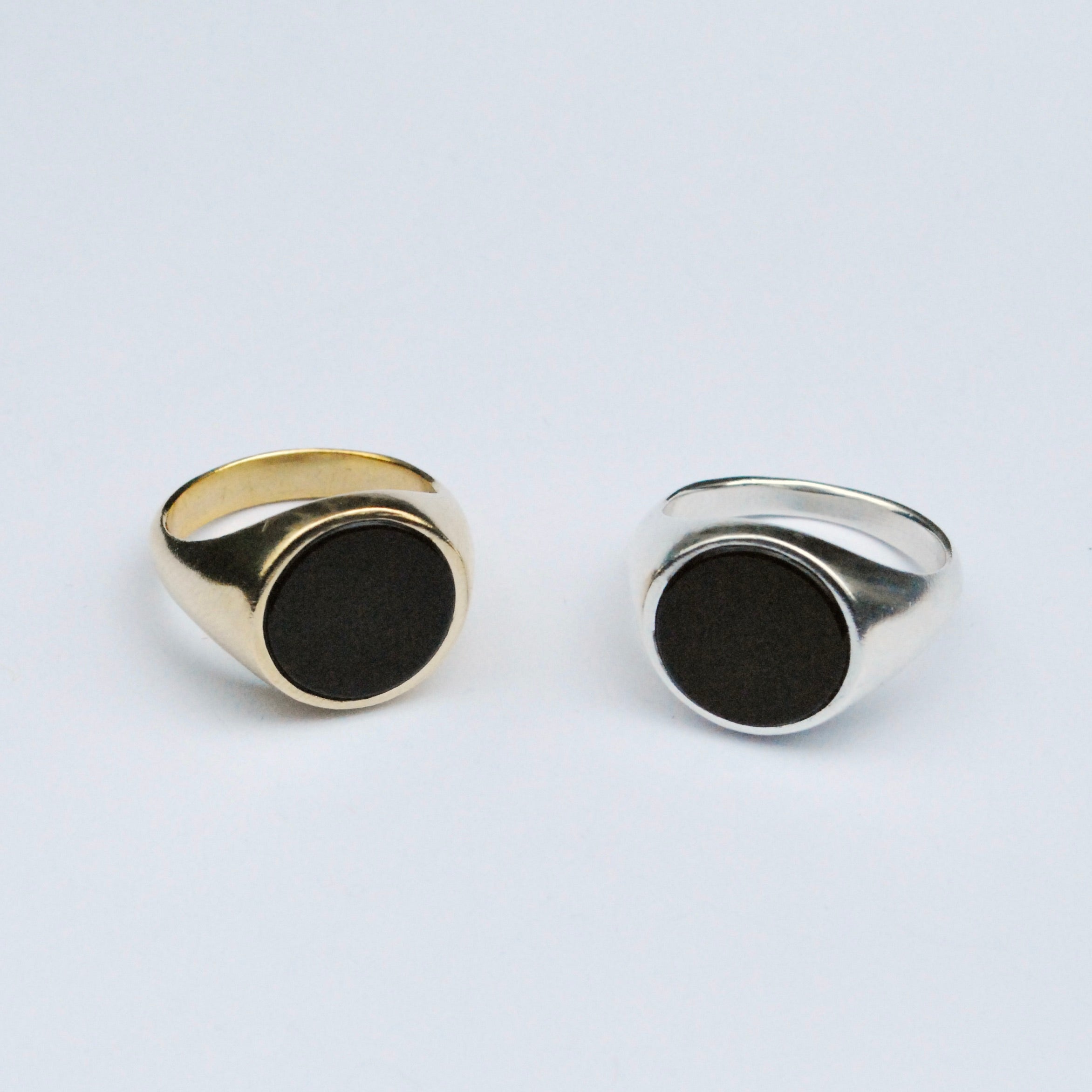 Two signet rings in bronze and silver with a round black onyx inlay