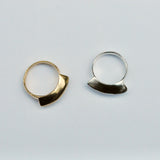 Top view of two fan shaped rings, one bronze and one silver