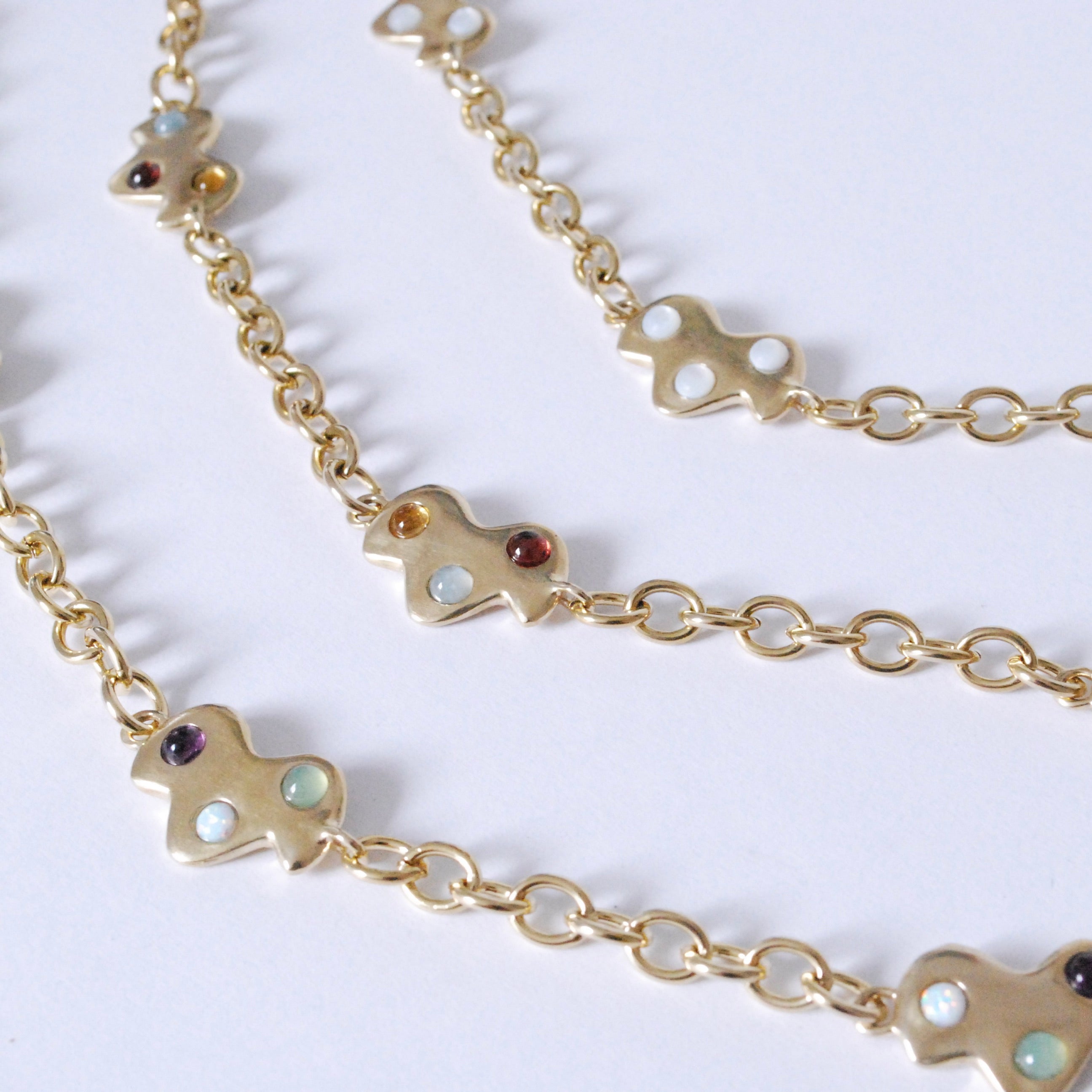 Gold colored confetti cloud necklaces on a white background in 3 different color options