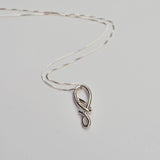 Silver necklace with a unique knot pendant on a light gray background