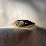 An oblong gold ring with three bicolor sapphires flush set in the surface
