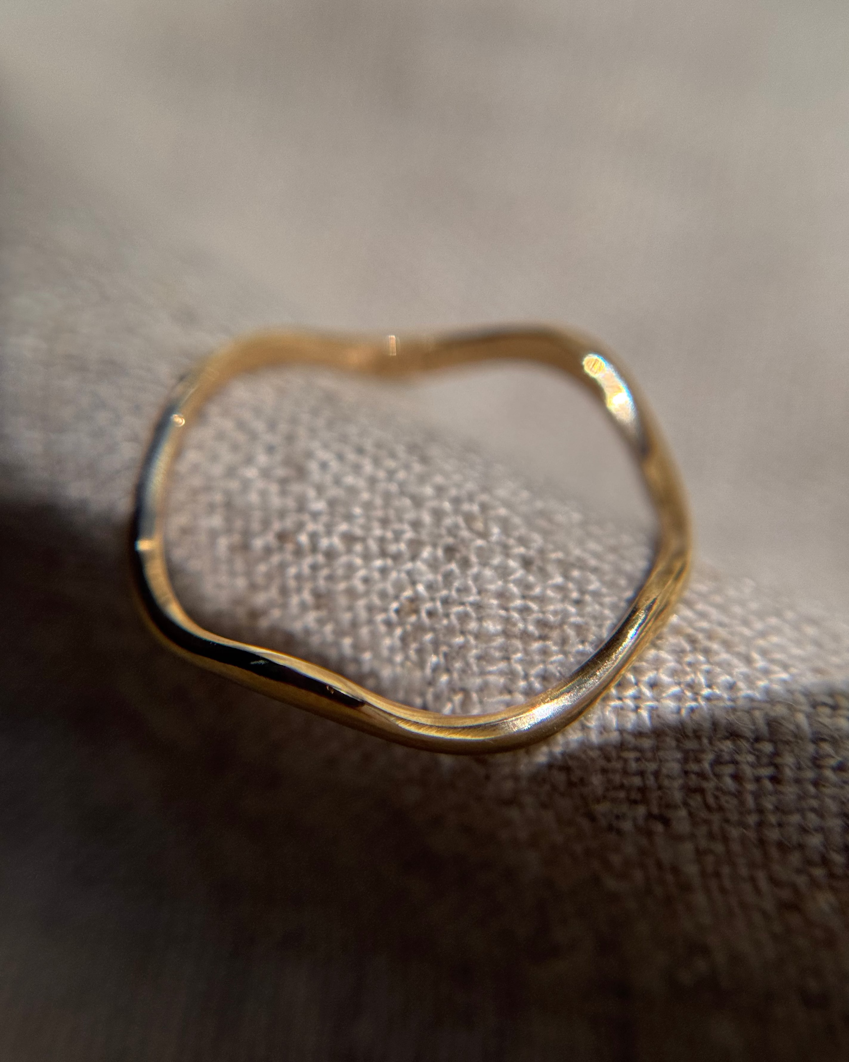 Top view of delicate gold wavy ring
