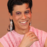 Person wearing a bronze split shape ring with a pyramid and sphere
