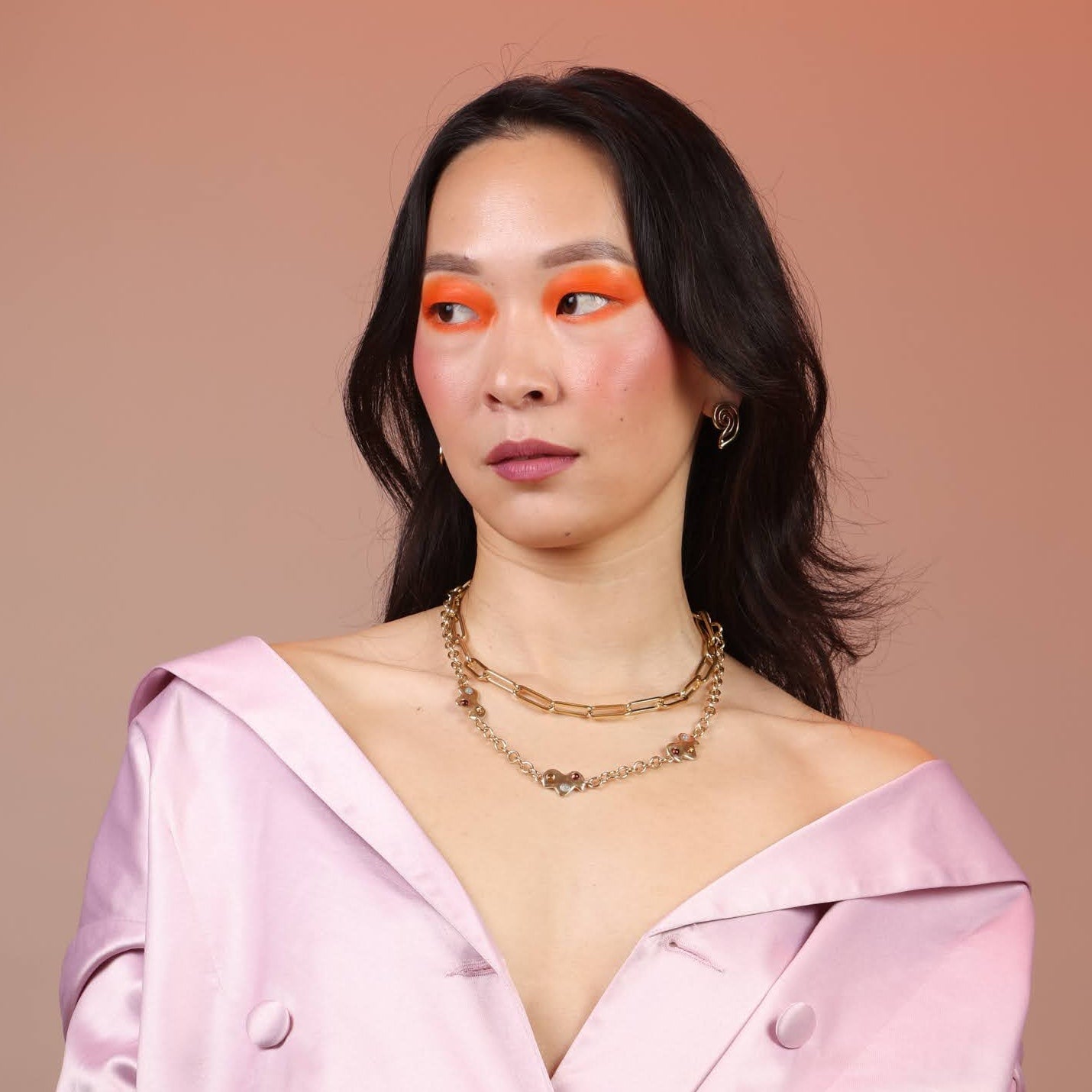 A person wearing the Confetti Cloud Charm Necklace with three charms, displayed against a neutral background.