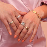 Person wearing an array of gold and silver jewelry