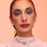 A woman wearing a silver necklace made of spiral pendant links