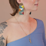 Person wearing a bronze knot necklace