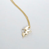 A graphic necklace with a geometric pendant, displayed on a plain background.