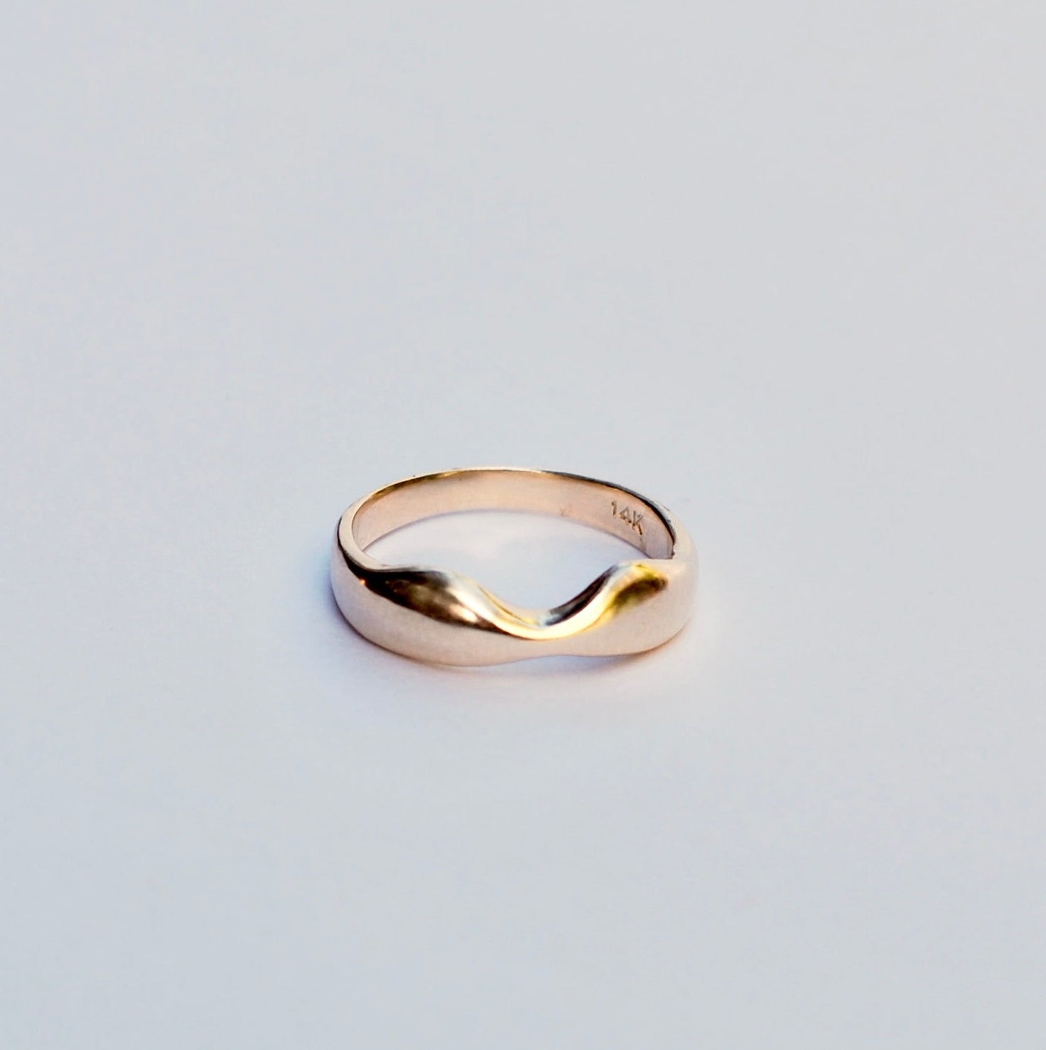 Gold ring on a light gray background