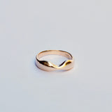 Gold ring on a light gray background