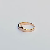 Gold ring on a light gray background