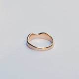 Gold ring on a light gray background