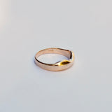 Gold ring on a light gray background