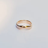 Gold ring on a light gray background