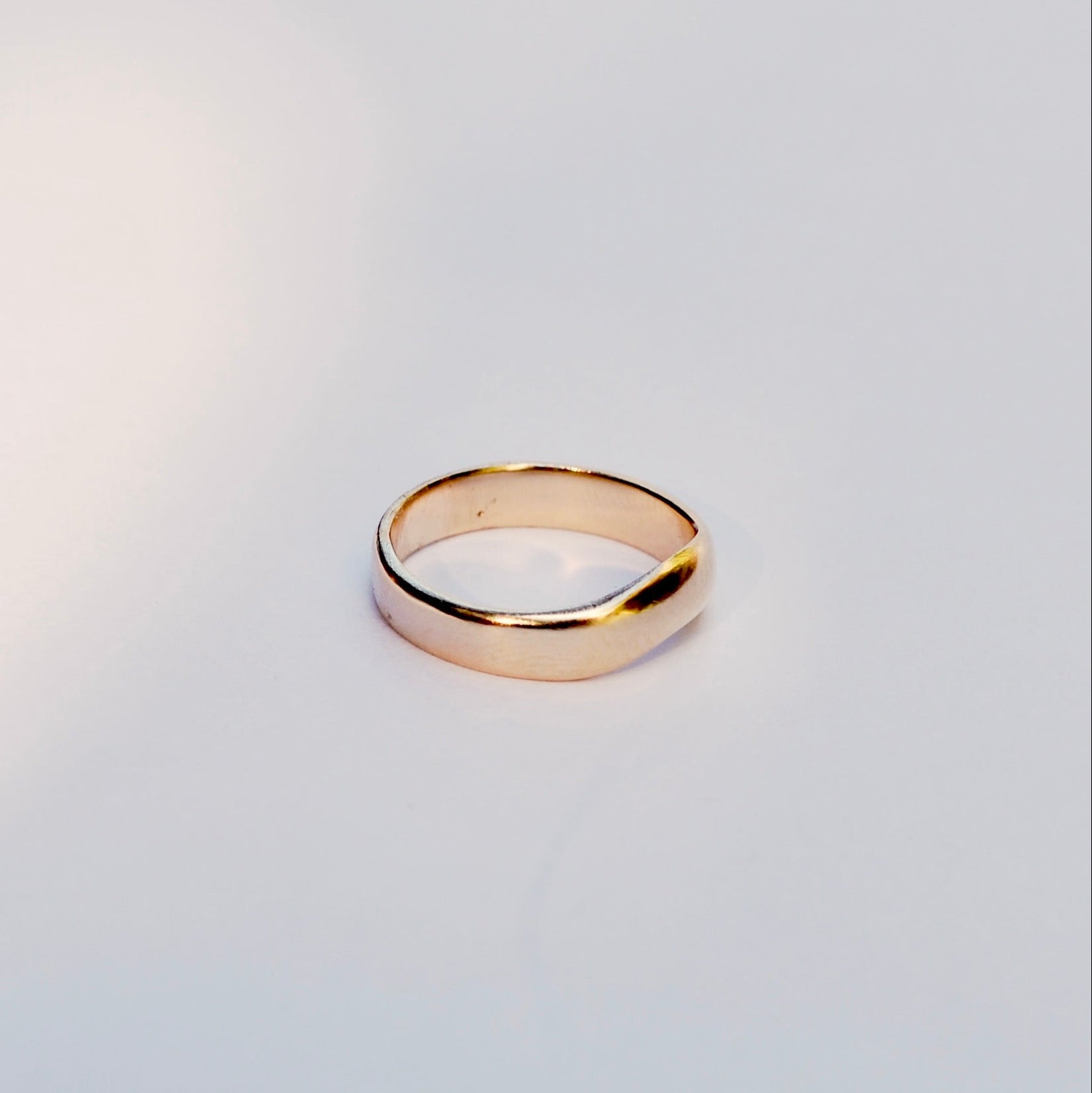 Gold ring on a light gray background
