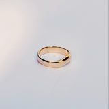Gold ring on a light gray background