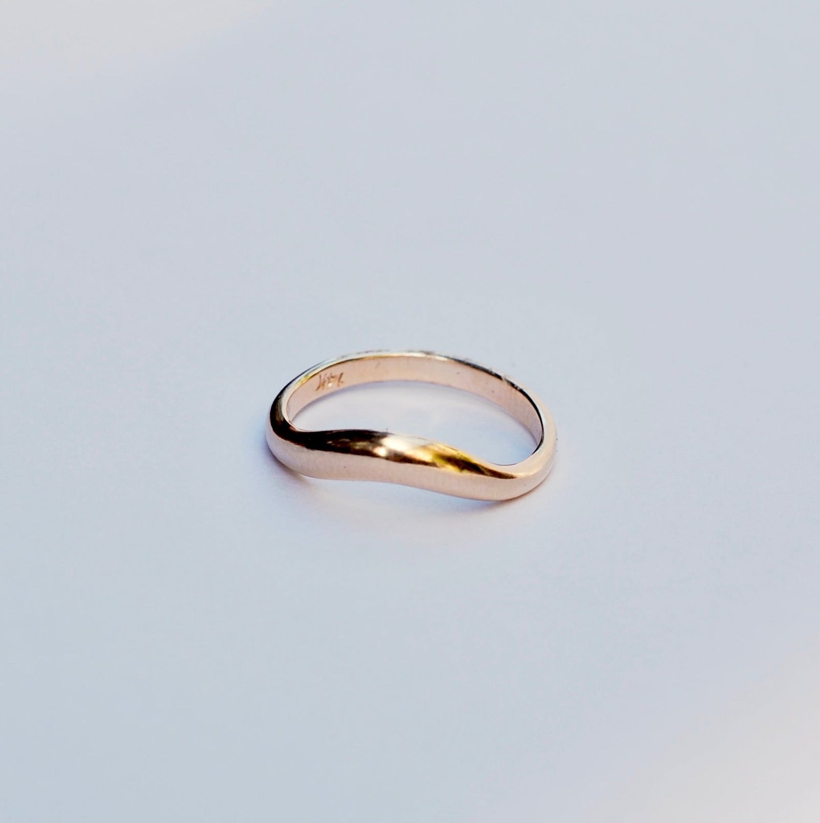 Gold ring on a light gray background