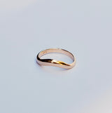 Gold ring on a light gray background