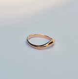 Gold ring on a light gray background