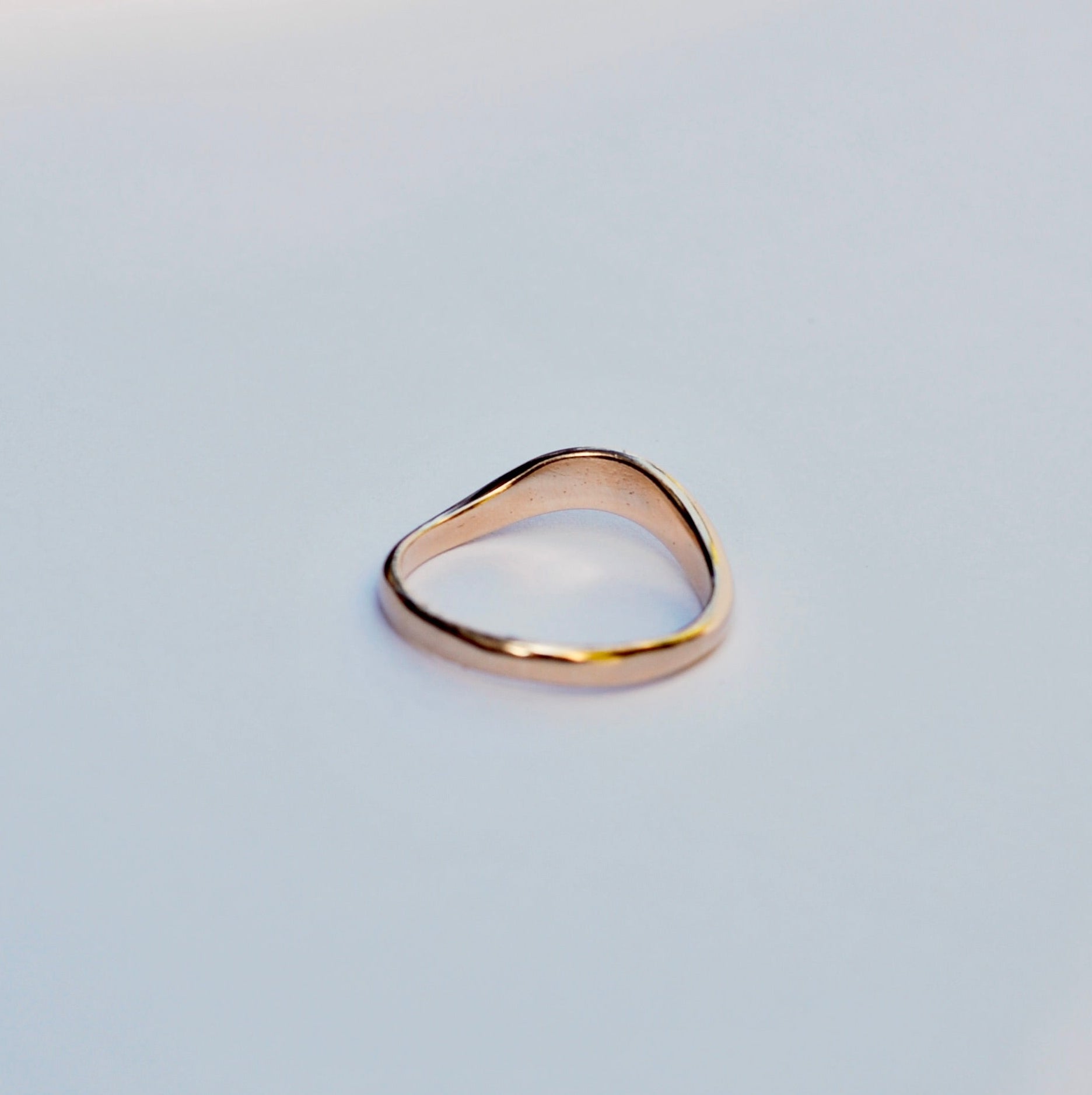 Gold ring on a light gray background