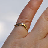 Gold ring on a finger with a blurred background