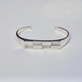 Silver cuff bracelet with a checkerboard pattern