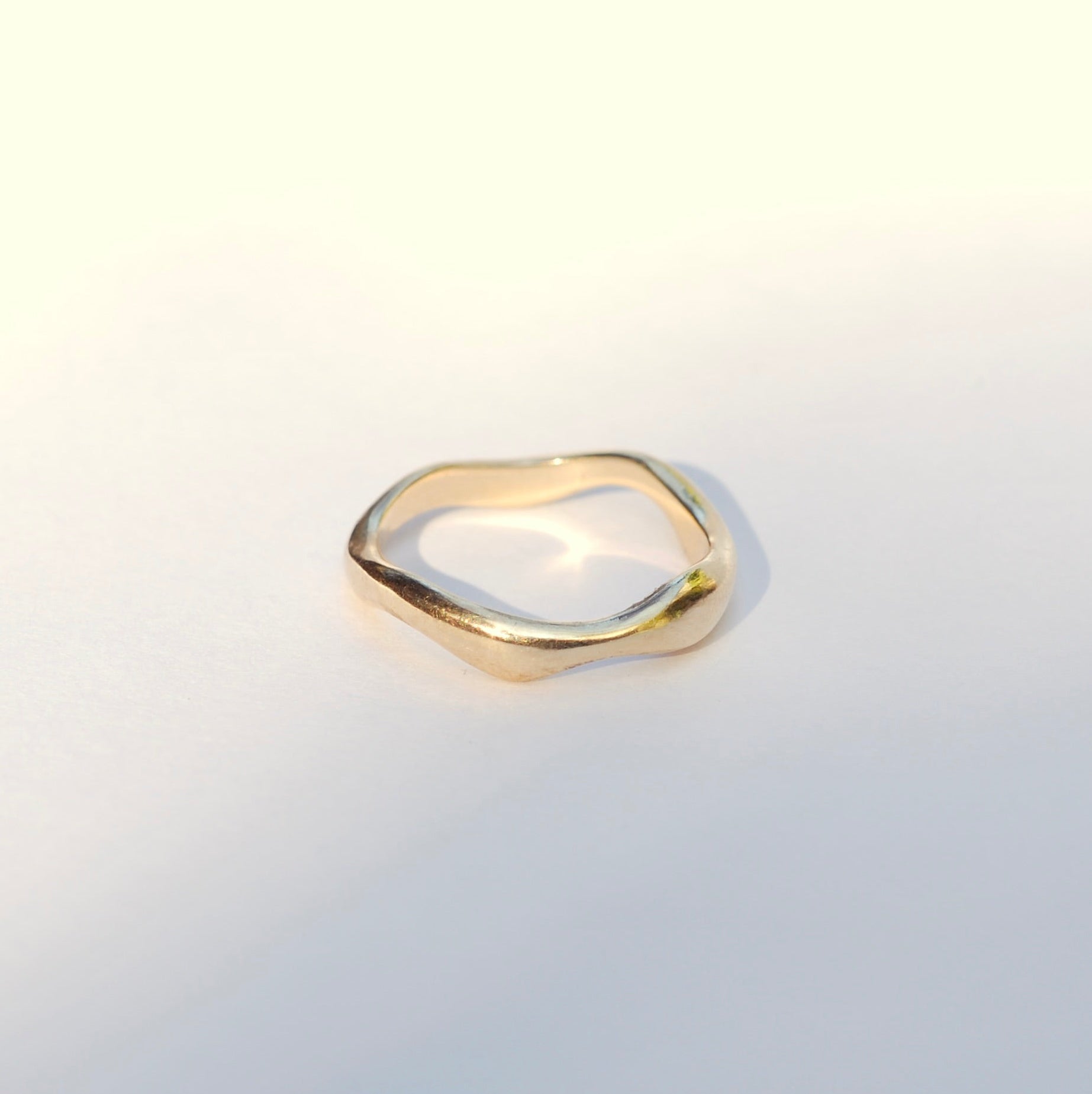 Gold ring on a light gray background