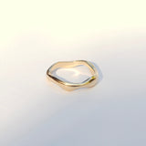 Gold ring on a light gray background