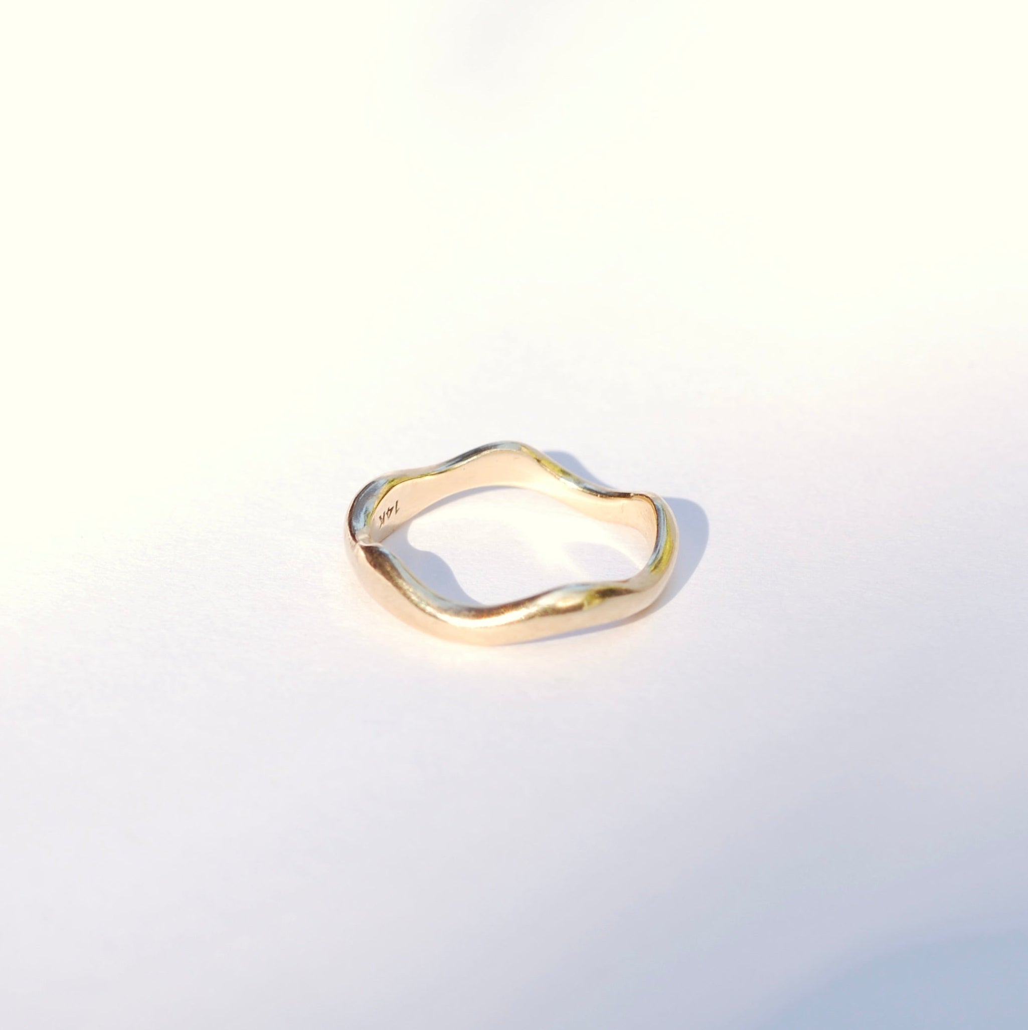 Gold ring on a light gray background