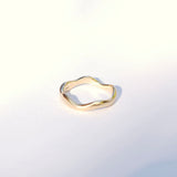 Gold ring on a light gray background