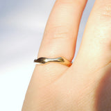 Gold ring on a finger with a blurred background