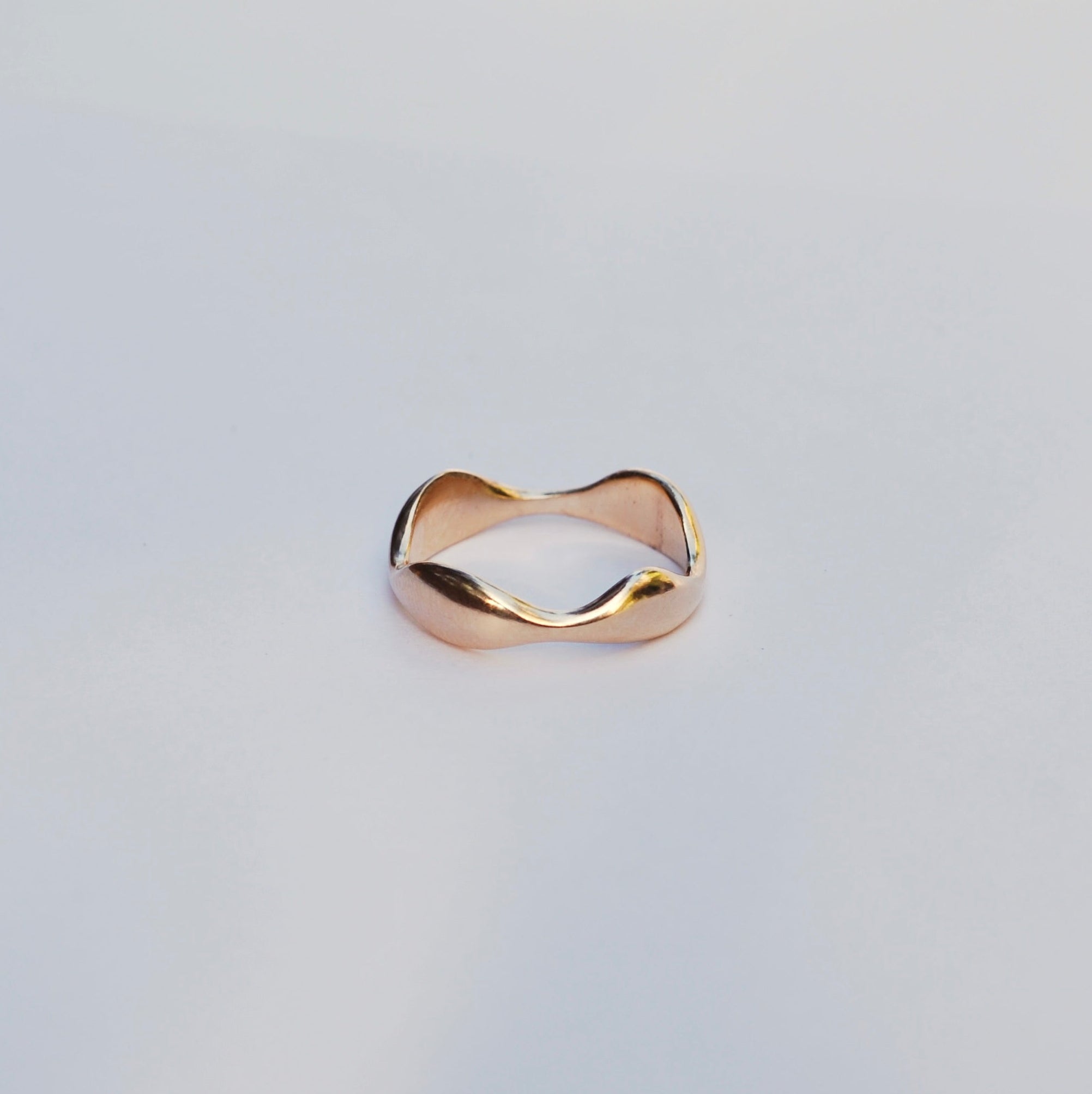 Gold ring on a light gray background