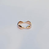 Gold ring on a light gray background