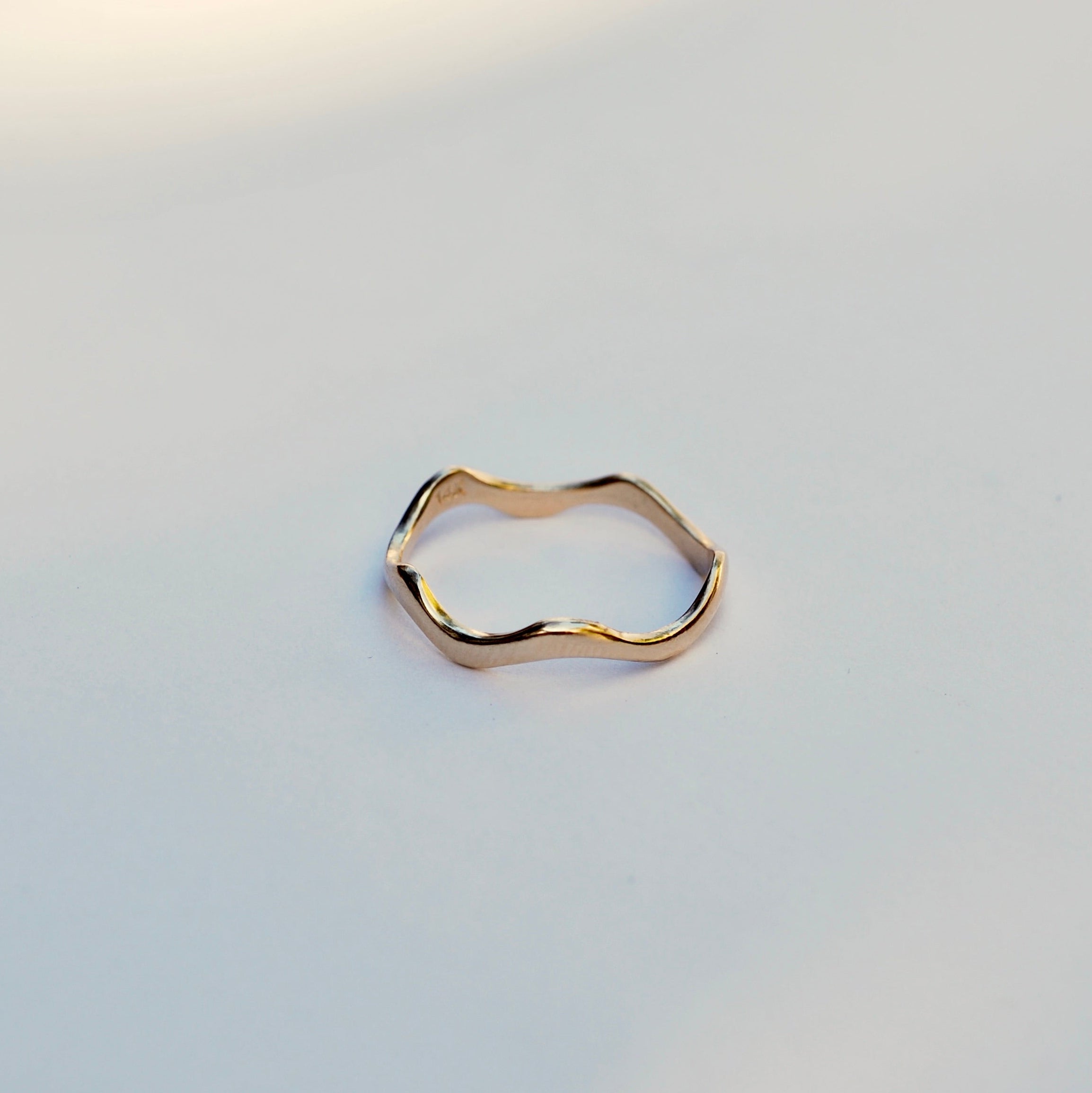 Gold ring on a light gray background
