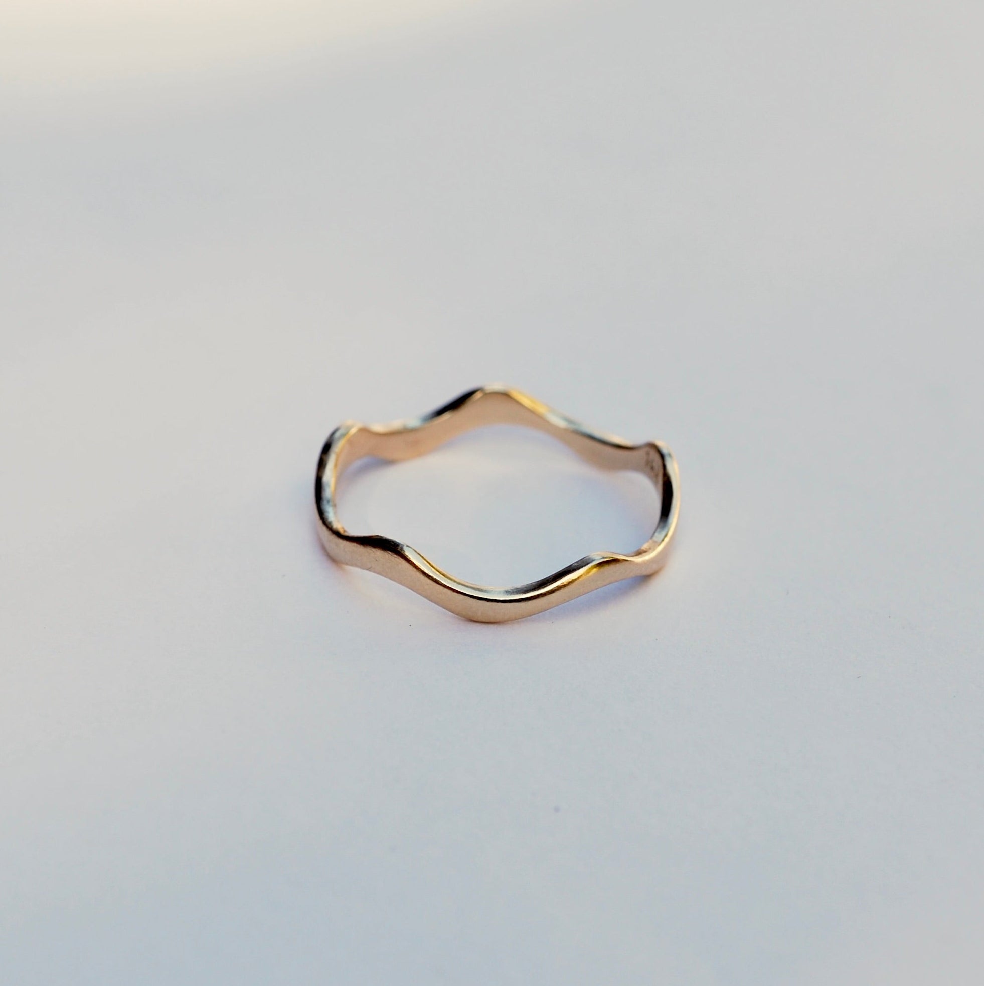 Gold ring on a light gray background