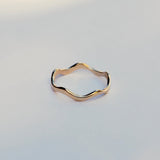 Gold ring on a light gray background