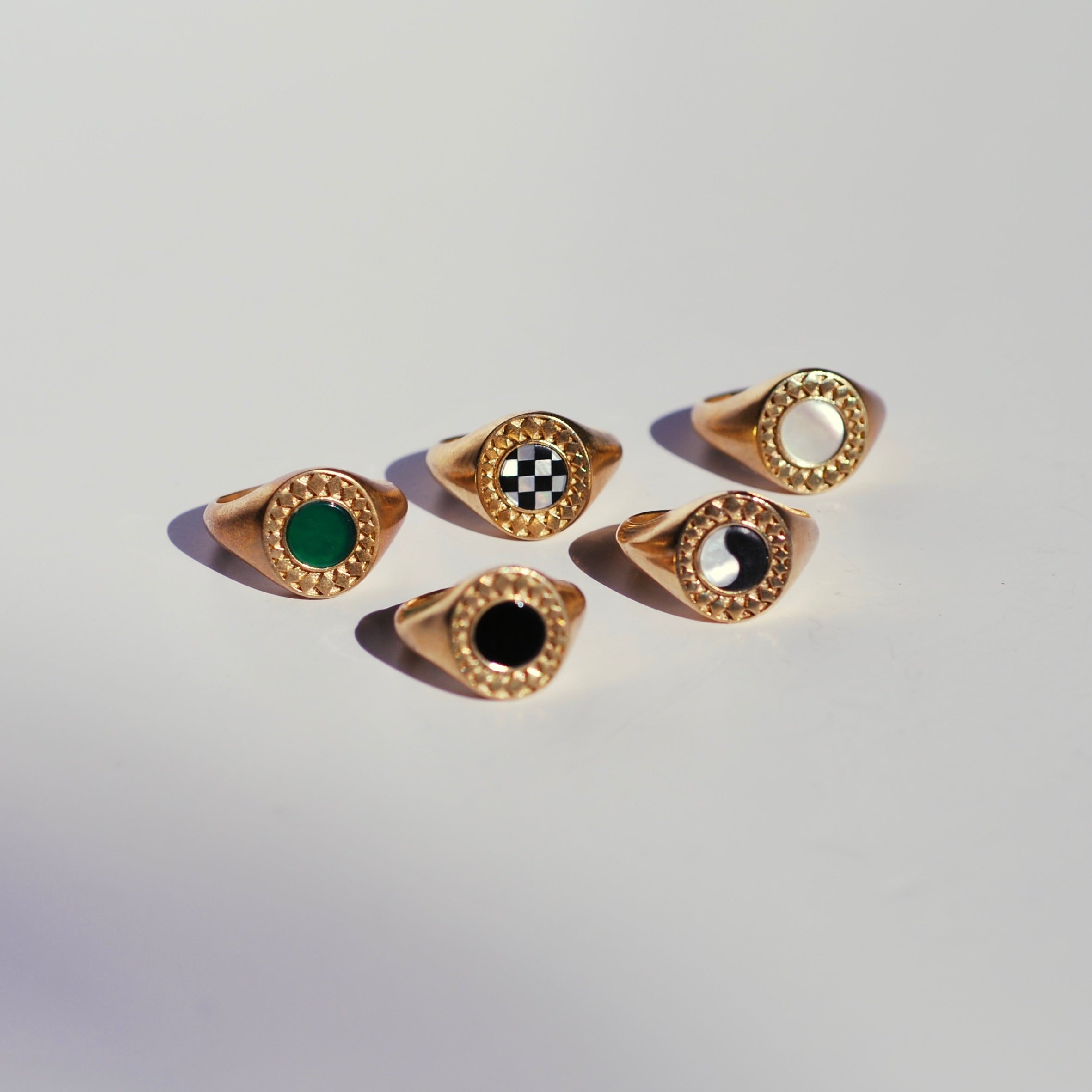 Five bronze  signet ring with different center round stone options surrounded by a diamond burst border