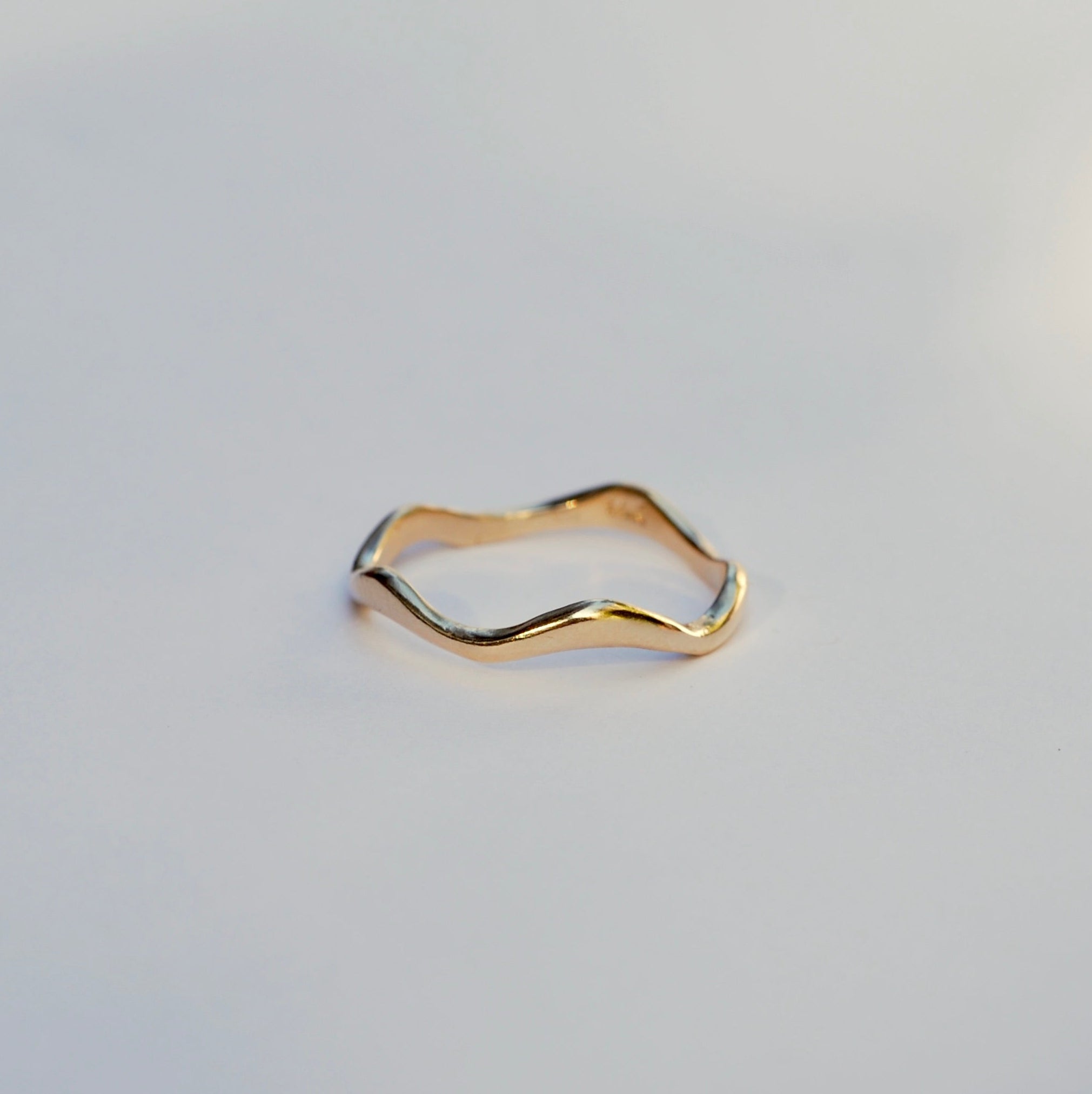 Gold ring on a light gray background