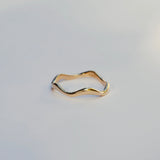 Gold ring on a light gray background