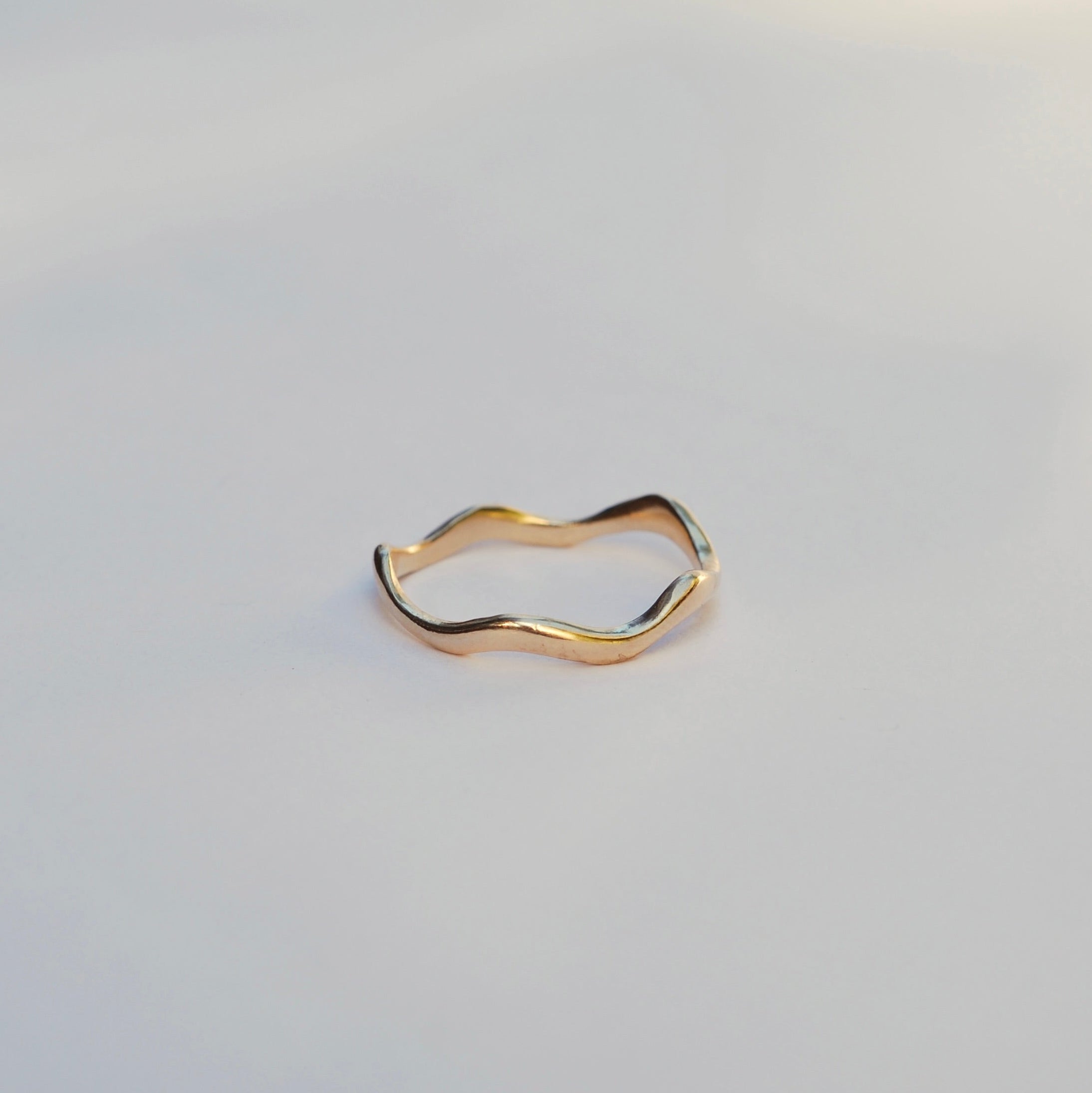 Gold ring on a light gray background