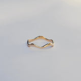 Gold ring on a light gray background