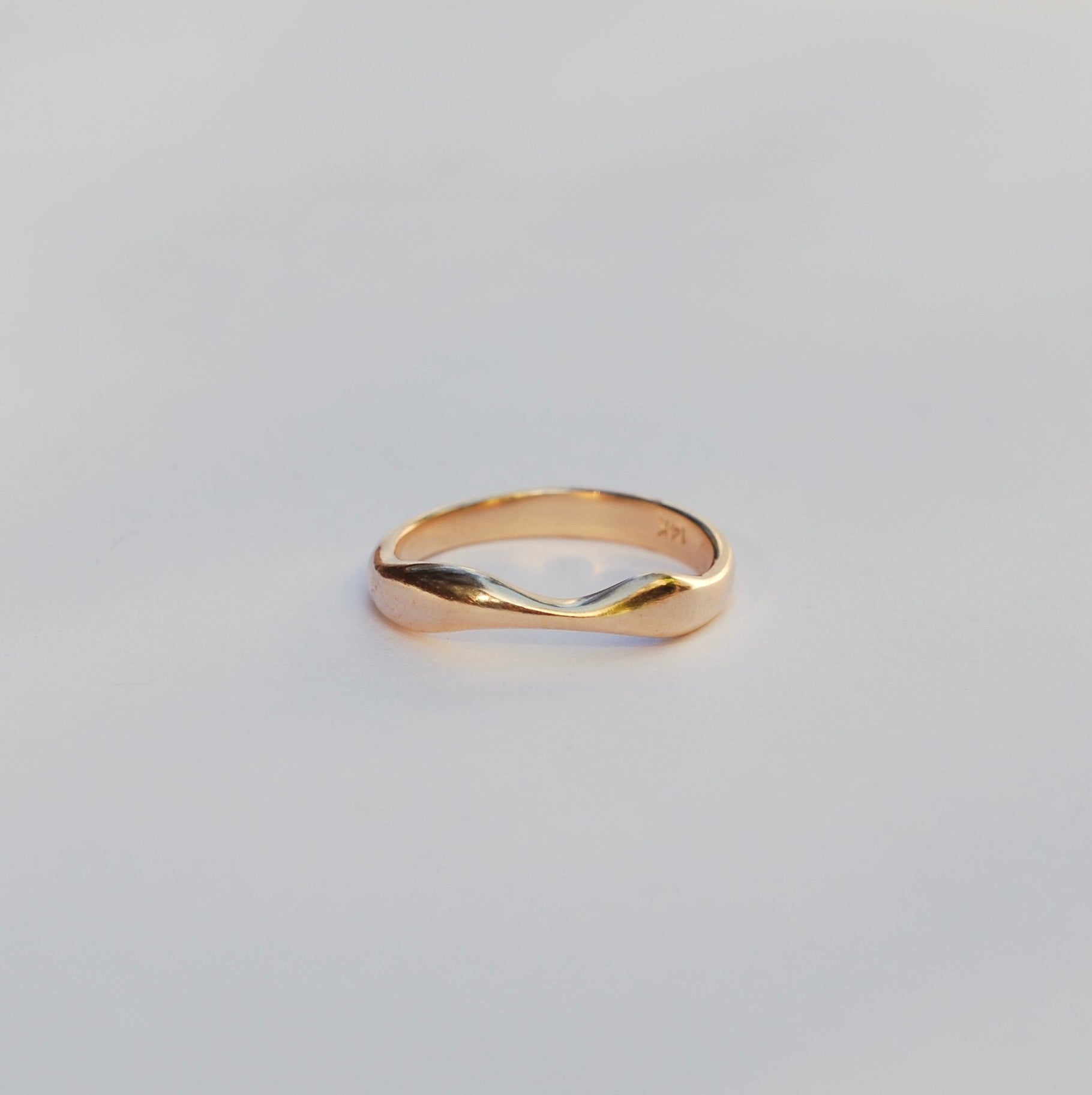 Gold ring on a light gray background