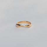 Gold ring on a light gray background