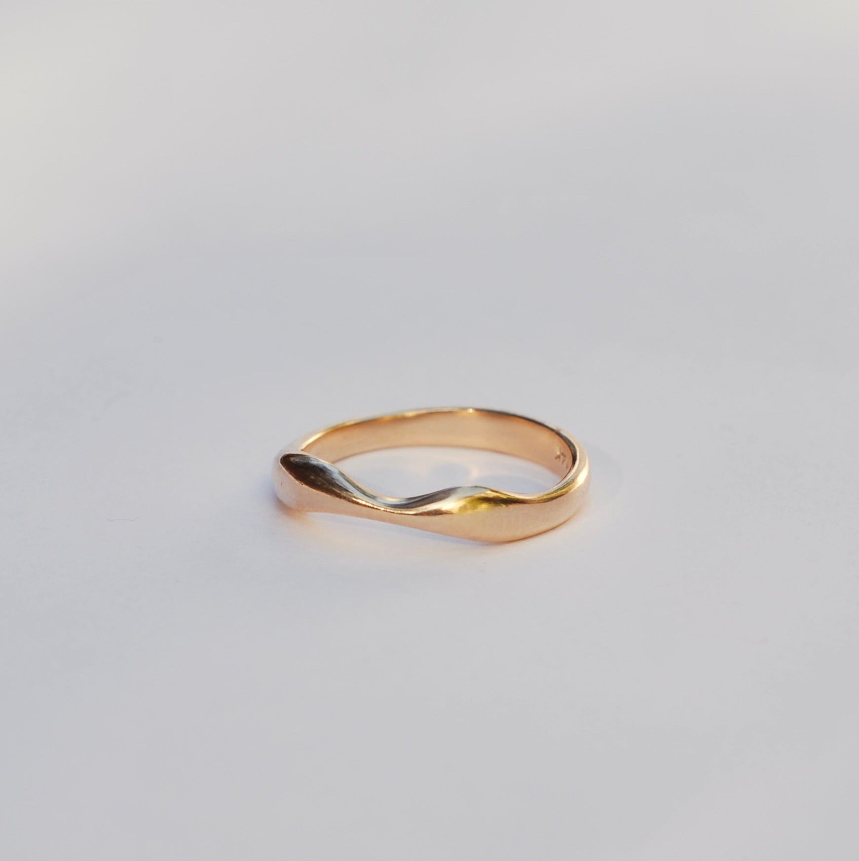 Gold ring on a light gray background