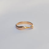 Gold ring on a light gray background