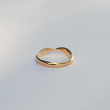 Gold ring on a light gray background