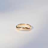 Gold ring on a light gray background