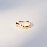 Gold ring on a light gray background